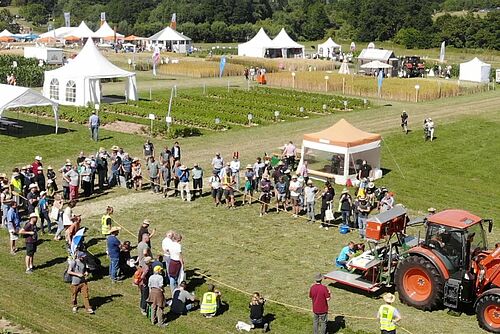 Maschinenvorführung von oben, weisse Pavillons im Hintergrund