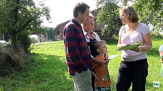 Beraterin erläutert der Bauernfamilie eine Biodiversitätsmassnahme