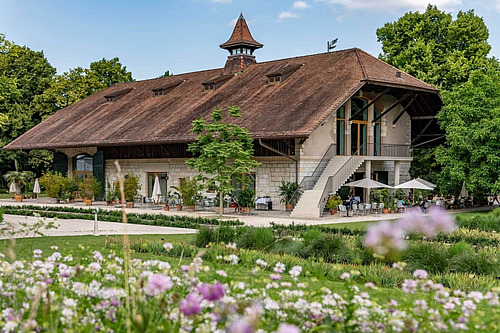 Eine renovierte alte Scheune in einem blumenreichen Garten. 